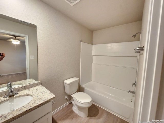 full bathroom with shower / bath combination, vanity, hardwood / wood-style floors, and toilet