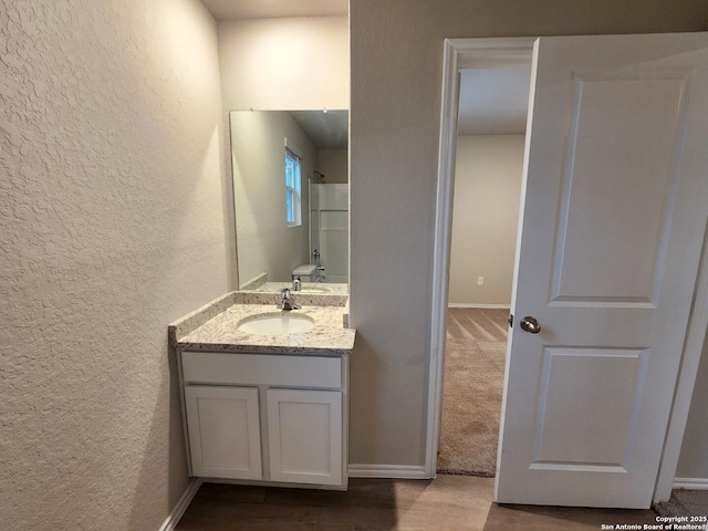 bathroom with vanity and hardwood / wood-style floors