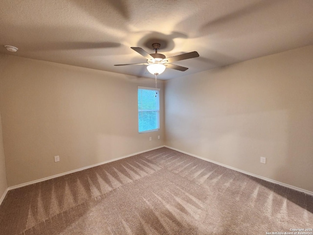 carpeted spare room featuring a textured ceiling and ceiling fan