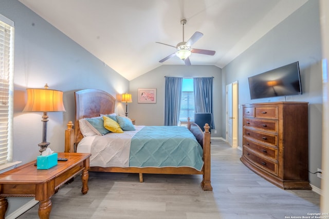 bedroom with lofted ceiling, ceiling fan, and light wood-type flooring