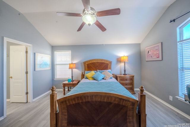 bedroom with ceiling fan, lofted ceiling, and light hardwood / wood-style floors