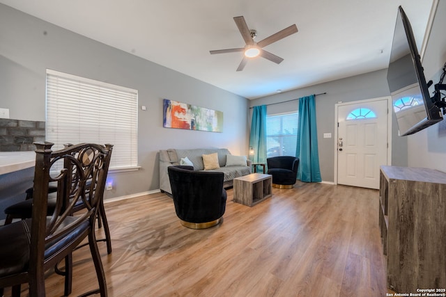 living room with ceiling fan and light hardwood / wood-style flooring