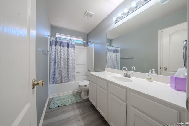 full bathroom featuring vanity, wood-type flooring, shower / bath combination with curtain, and toilet