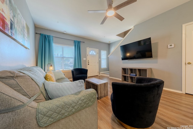 living room featuring hardwood / wood-style floors, vaulted ceiling, and ceiling fan