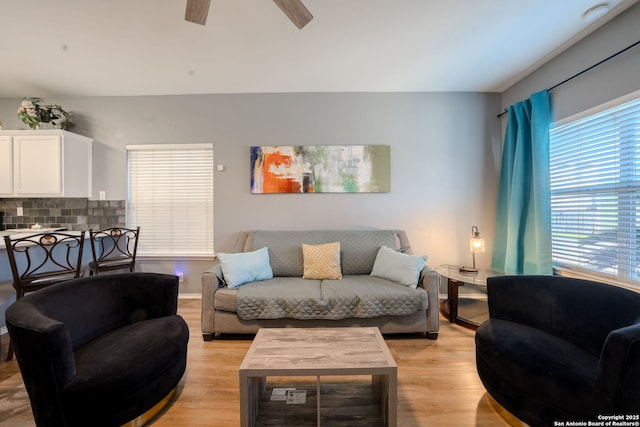 living room featuring ceiling fan and light wood-type flooring