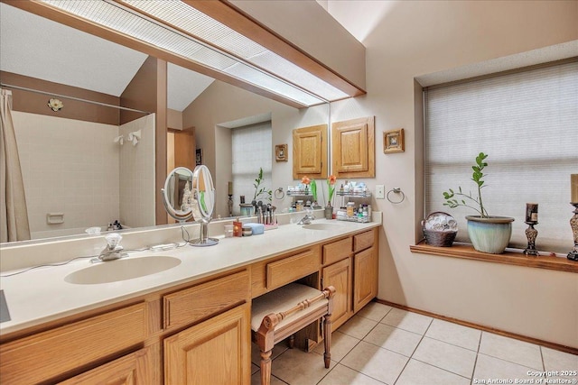 bathroom with tile patterned flooring, vanity, vaulted ceiling, and shower / bath combo with shower curtain