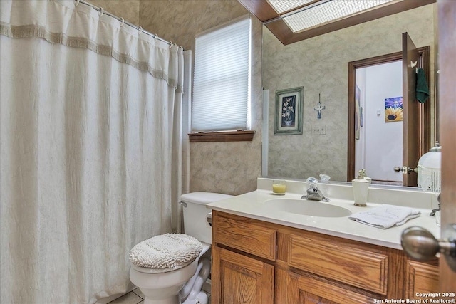 bathroom featuring vanity, a shower with shower curtain, and toilet