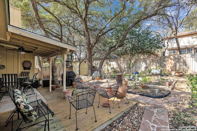 view of patio with a wooden deck, a grill, and ceiling fan