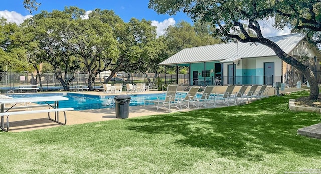 view of swimming pool with a patio and a lawn