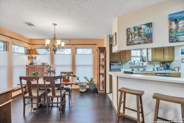 dining area featuring plenty of natural light, sink, and dark wood-type flooring