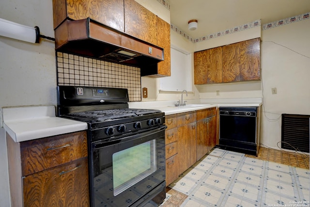 kitchen featuring premium range hood, sink, heating unit, decorative backsplash, and black appliances