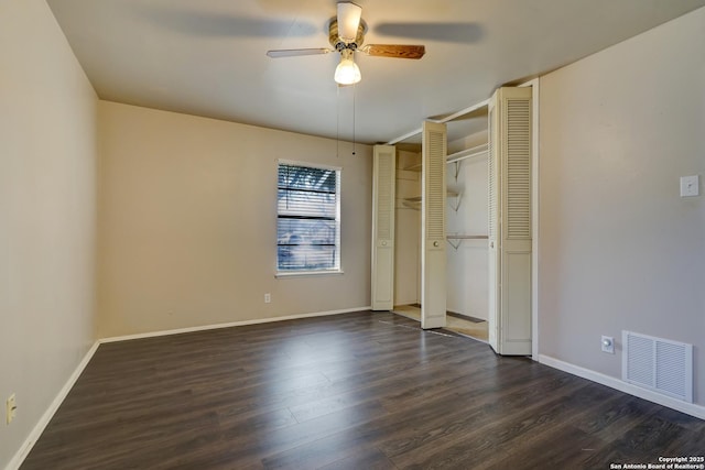 unfurnished bedroom with ceiling fan and dark hardwood / wood-style flooring