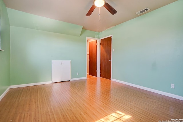 spare room featuring hardwood / wood-style floors and ceiling fan