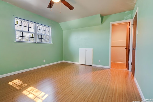 bonus room with lofted ceiling, light hardwood / wood-style floors, and ceiling fan