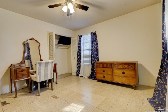 interior space featuring ceiling fan and a closet