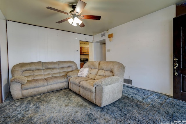 living room featuring ceiling fan and carpet flooring