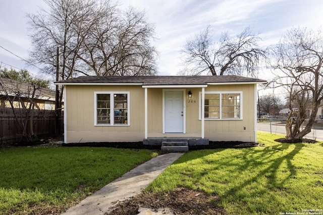 bungalow-style house with a front lawn