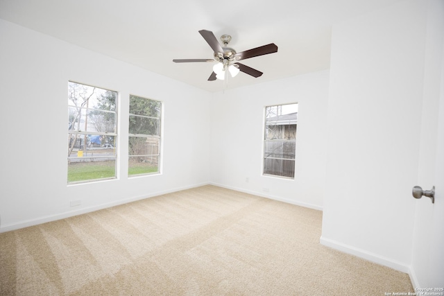 unfurnished room featuring light colored carpet and ceiling fan