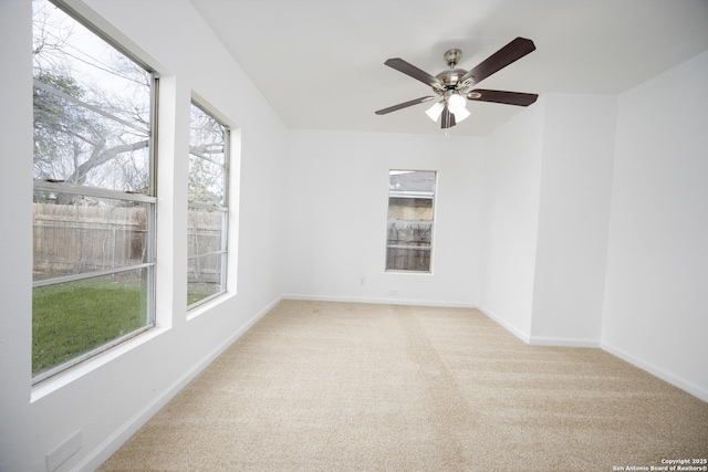 carpeted empty room featuring ceiling fan