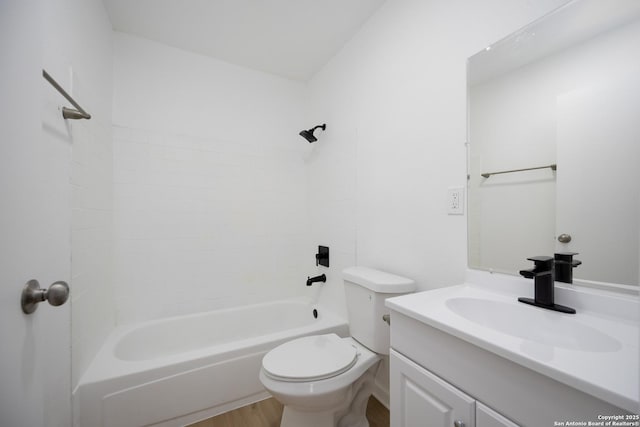 full bathroom with vanity, hardwood / wood-style floors, washtub / shower combination, and toilet