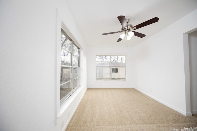 unfurnished sunroom featuring ceiling fan