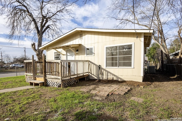 back of property featuring central AC unit and a deck