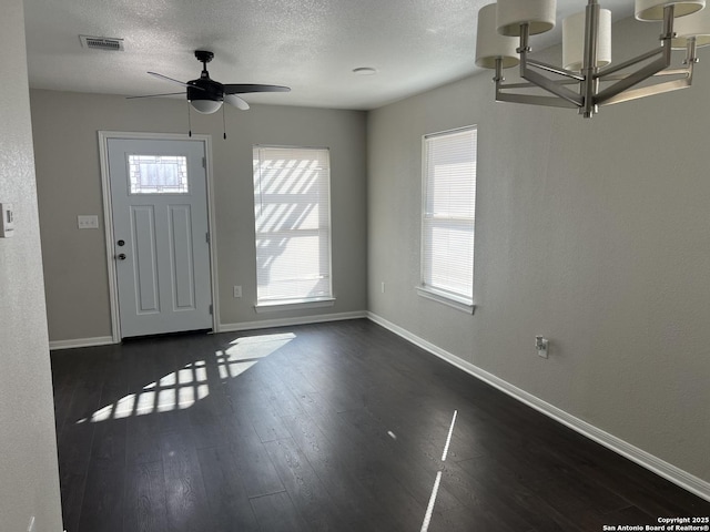 entryway featuring ceiling fan, a wealth of natural light, dark hardwood / wood-style floors, and a textured ceiling