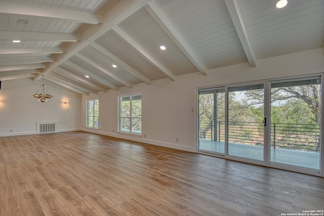 unfurnished living room with an inviting chandelier, wood-type flooring, and vaulted ceiling with beams