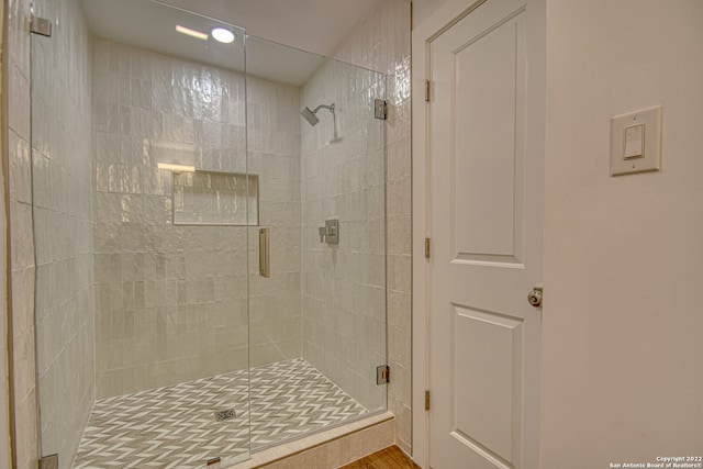 bathroom with a shower with shower door