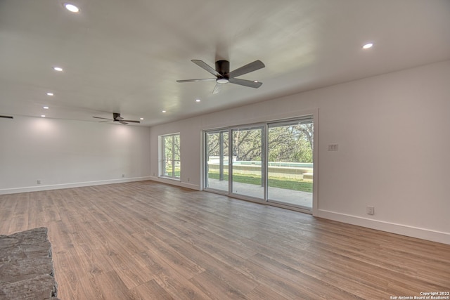 unfurnished room featuring light hardwood / wood-style floors and ceiling fan