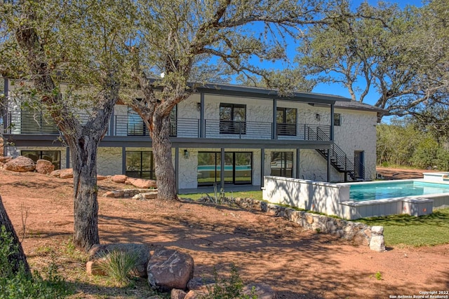 back of house with a balcony