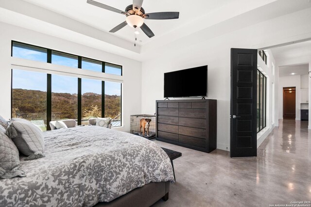 bedroom with a ceiling fan and concrete flooring