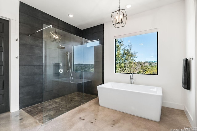 bathroom featuring a notable chandelier, recessed lighting, a freestanding tub, baseboards, and walk in shower