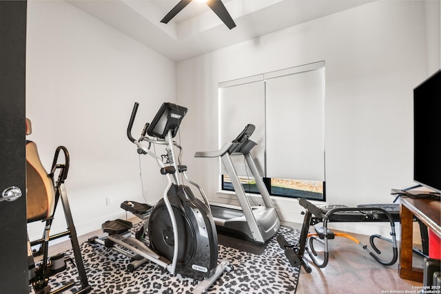 workout area with a ceiling fan and baseboards