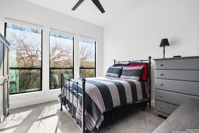 bedroom featuring ceiling fan and finished concrete flooring