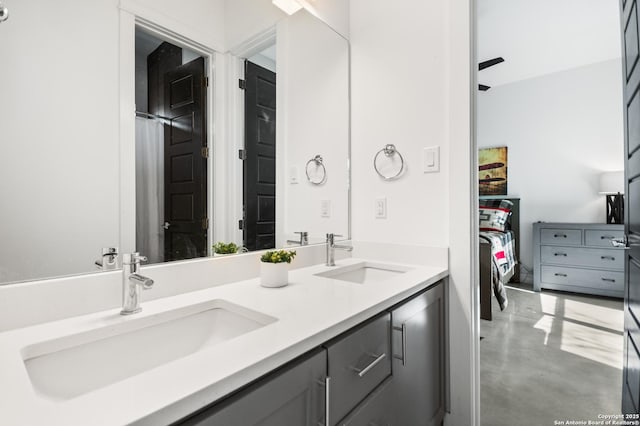 full bath featuring concrete flooring, a sink, and double vanity