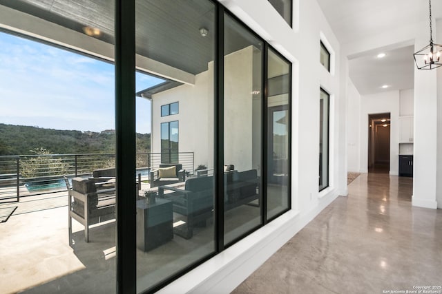 balcony with an outdoor living space and a view of trees