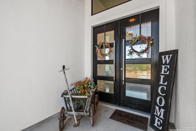 entrance to property with french doors and stucco siding