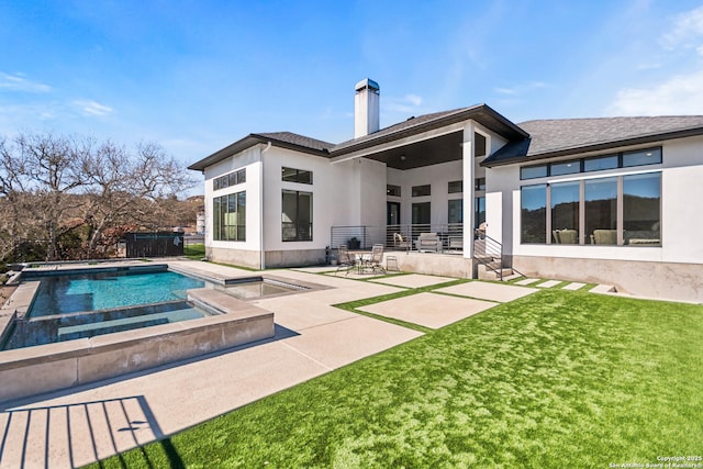 rear view of house with a fenced in pool, a patio, a chimney, an in ground hot tub, and stucco siding