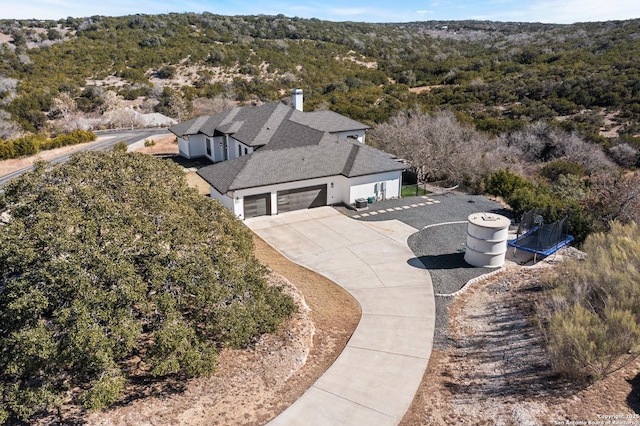 birds eye view of property with a forest view