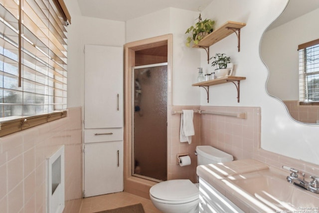 bathroom featuring sink, tile walls, tile patterned flooring, an enclosed shower, and toilet