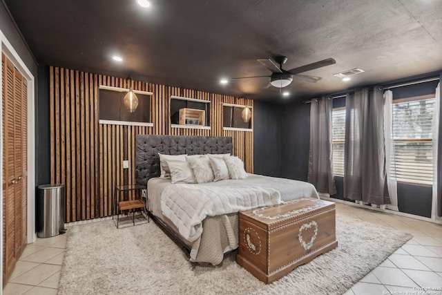 tiled bedroom featuring ceiling fan