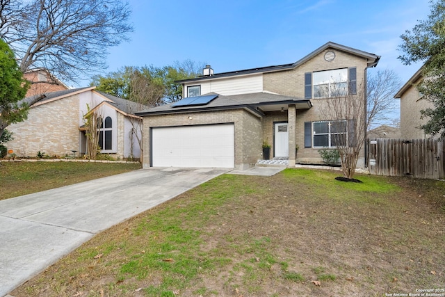 view of front of house with a garage, a front yard, and solar panels