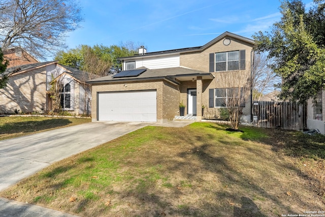 view of front of home featuring a garage, a front yard, and solar panels