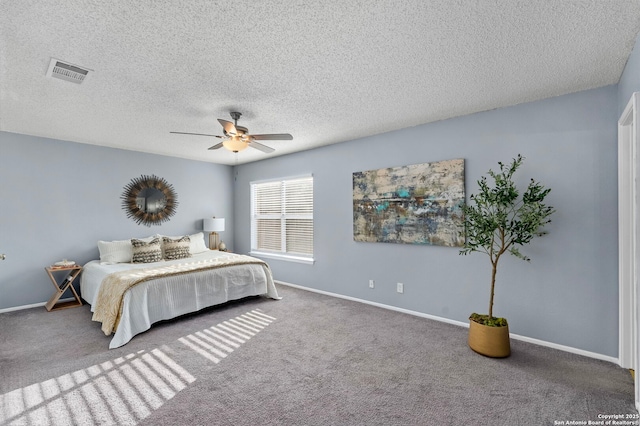 carpeted bedroom featuring a textured ceiling and ceiling fan