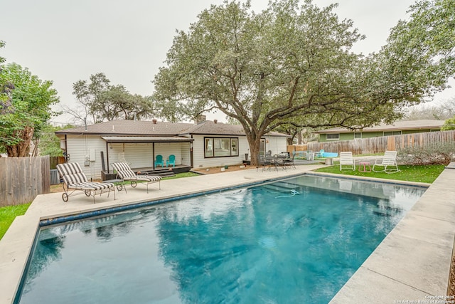 view of swimming pool with a fenced in pool, a fenced backyard, and a patio area