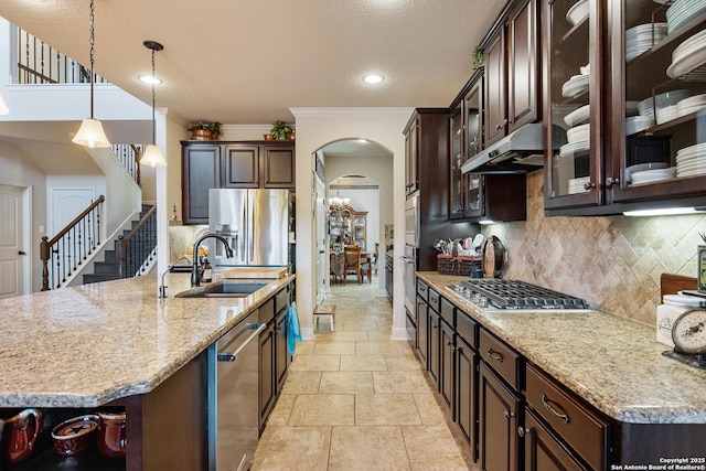 kitchen featuring stainless steel appliances, decorative light fixtures, sink, and dark brown cabinets