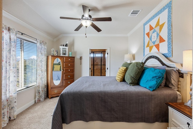 bedroom featuring ornamental molding, light colored carpet, and ceiling fan