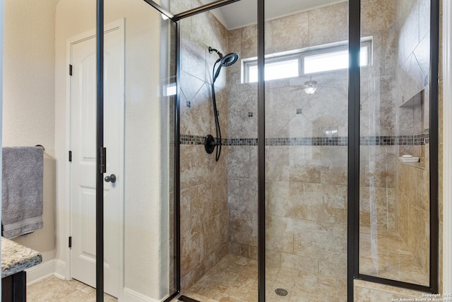 bathroom with a shower with door