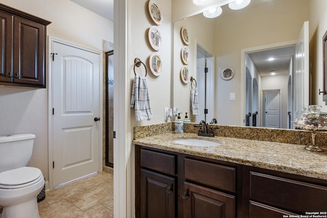 bathroom featuring vanity, tile patterned flooring, and toilet